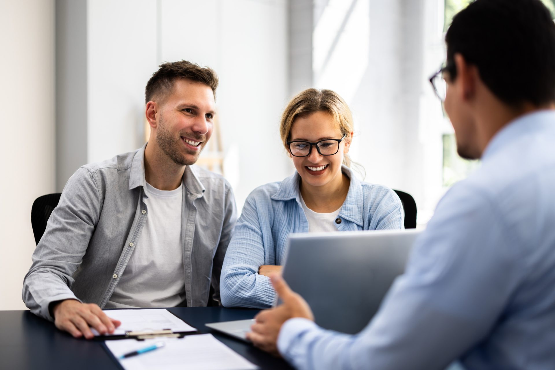 Smiling couple meeting with a financial advisor in an office